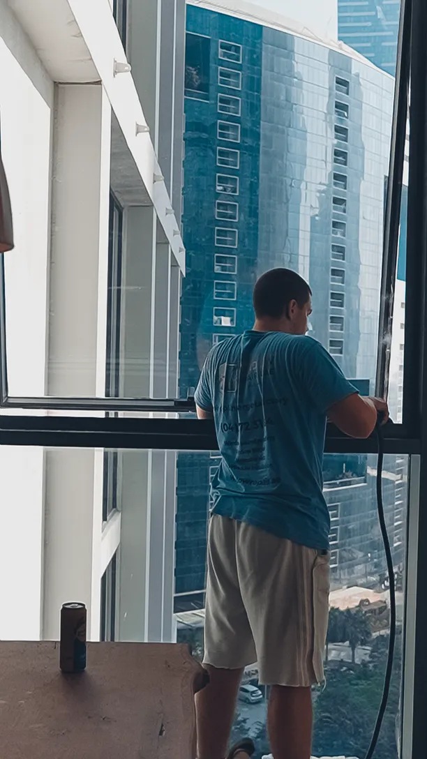 Window Repair UAE technician adjusting a casement window in a Dubai high-rise
