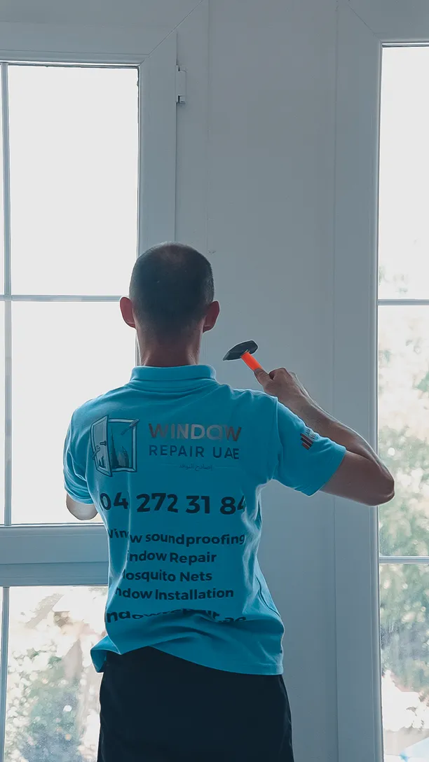 Technician fitting a window in a bright apartment room