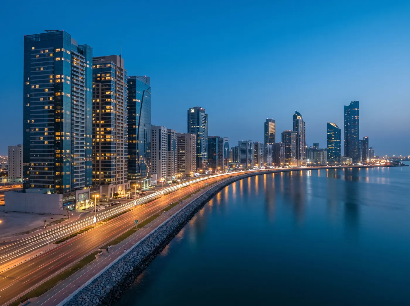 Abu Dhabi Corniche towers along the waterfront at blue hour