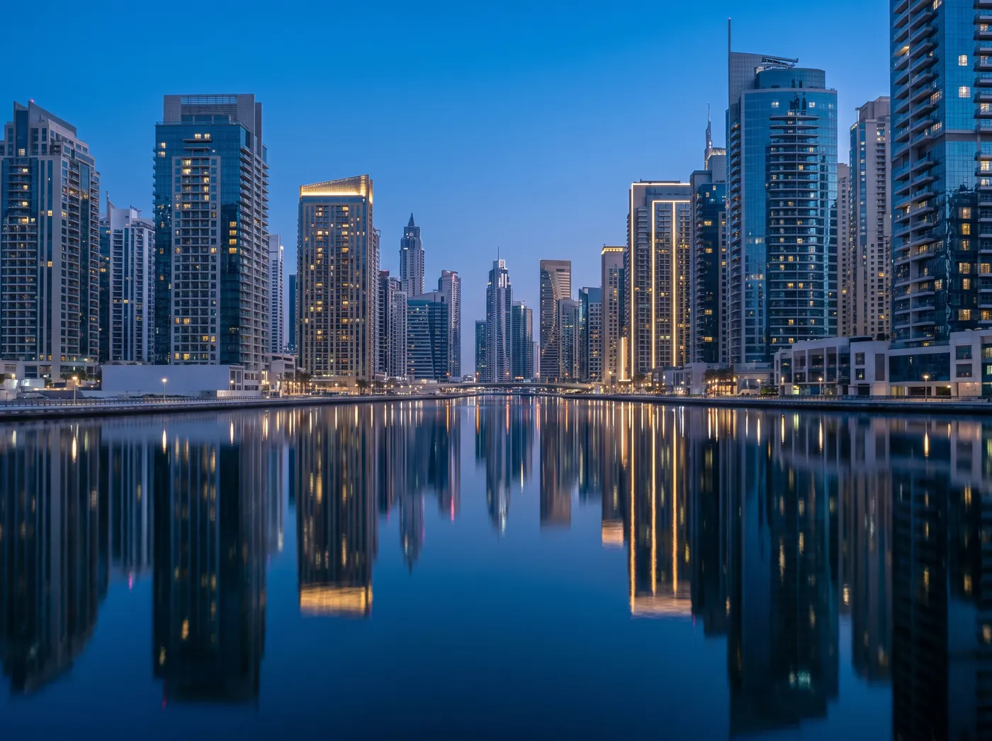 Business Bay towers along the Dubai Water Canal at blue hour