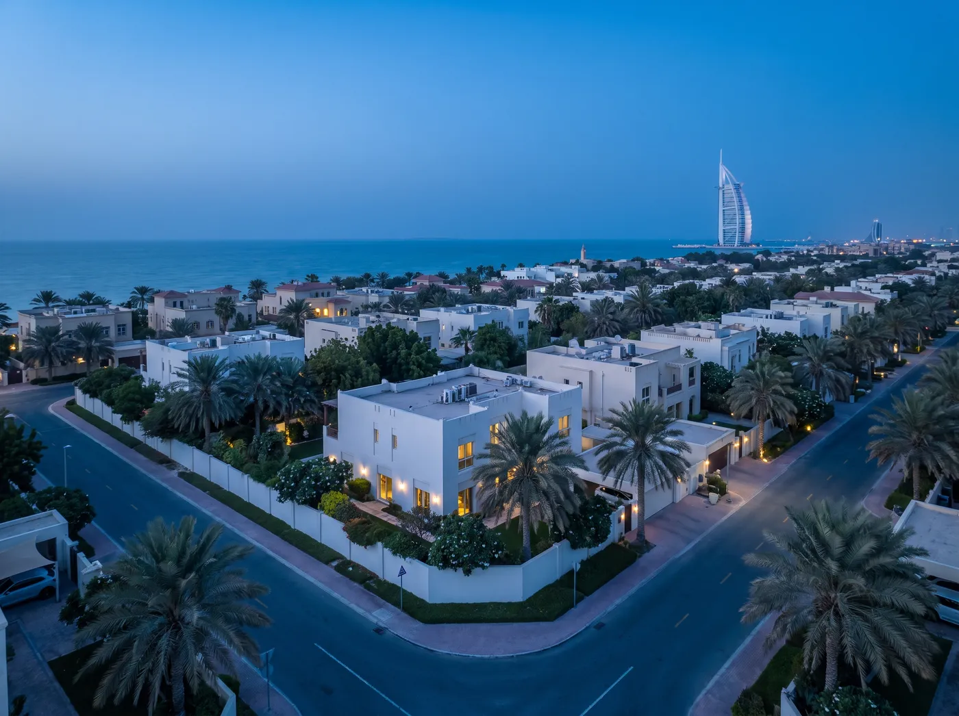 Jumeirah beachside villa district at blue hour with the sea beyond