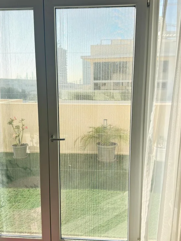 Panoramic sliding doors opening onto a Dubai terrace after repair