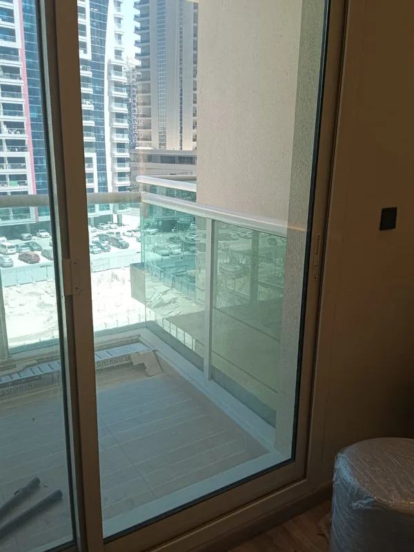 Balcony sliding door onto a Dubai city view after service