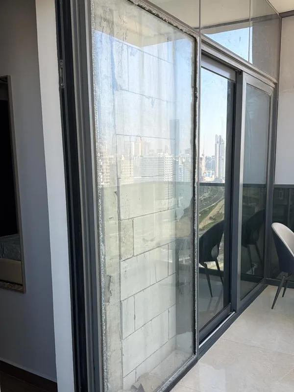 Floor-to-ceiling glazed partition doors aligned and sealed in a Dubai property