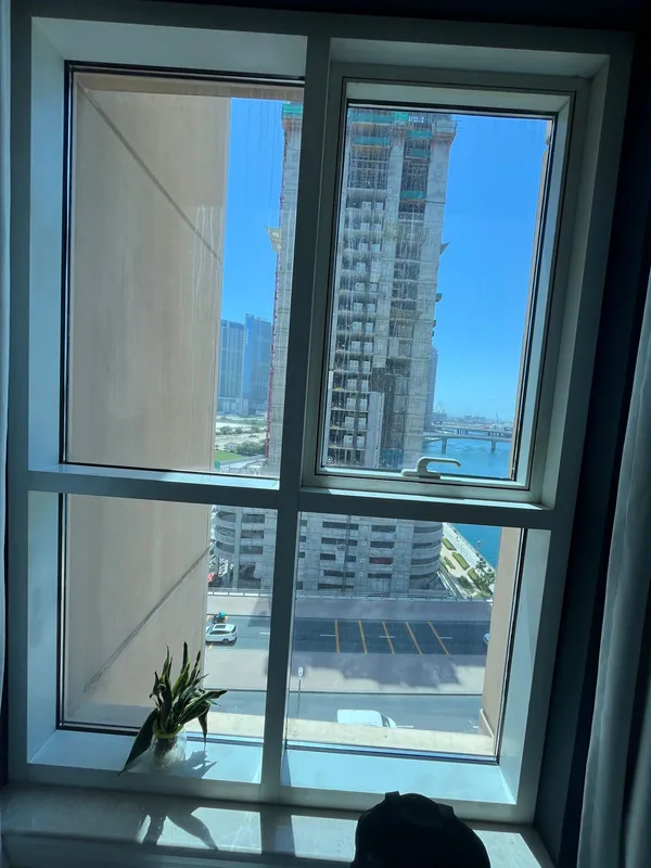 Repaired window opening onto a Dubai villa garden