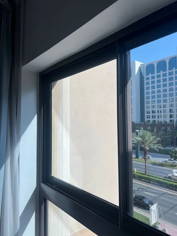 Repaired window opening onto a Dubai villa garden