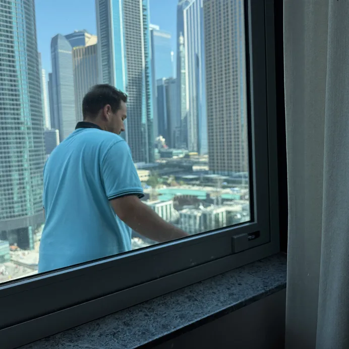 Technician holding the sash of an aluminium window open