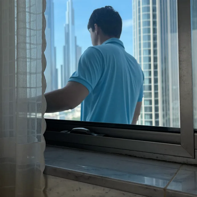 Technician servicing a fire door closer and seals in a Dubai building
