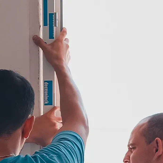 Two technicians bring a frame back to level
