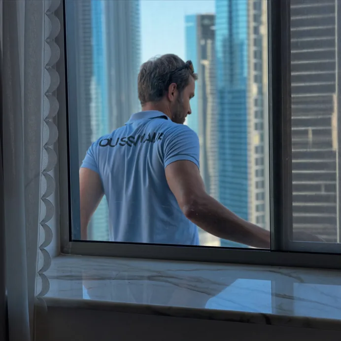 Technician in a branded polo working at a window sash