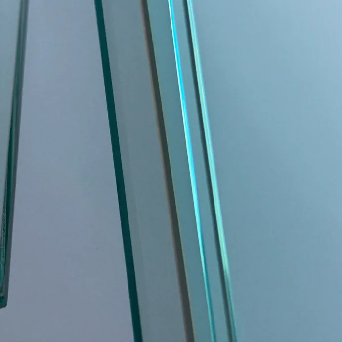 Close-up of laminated glass pane edges showing the layered structure