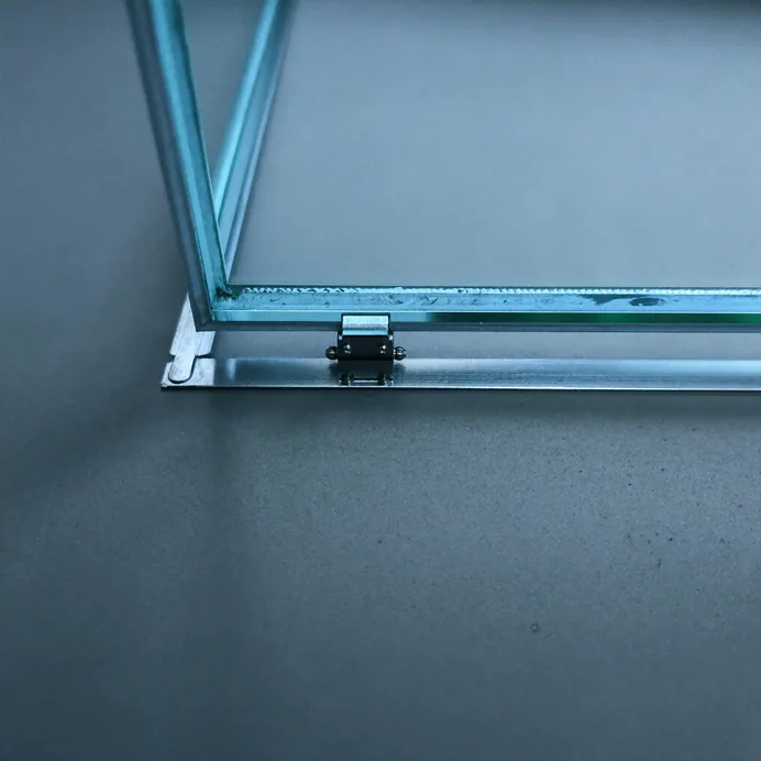 Close-up of a slim glass panel edge in an aluminium frame